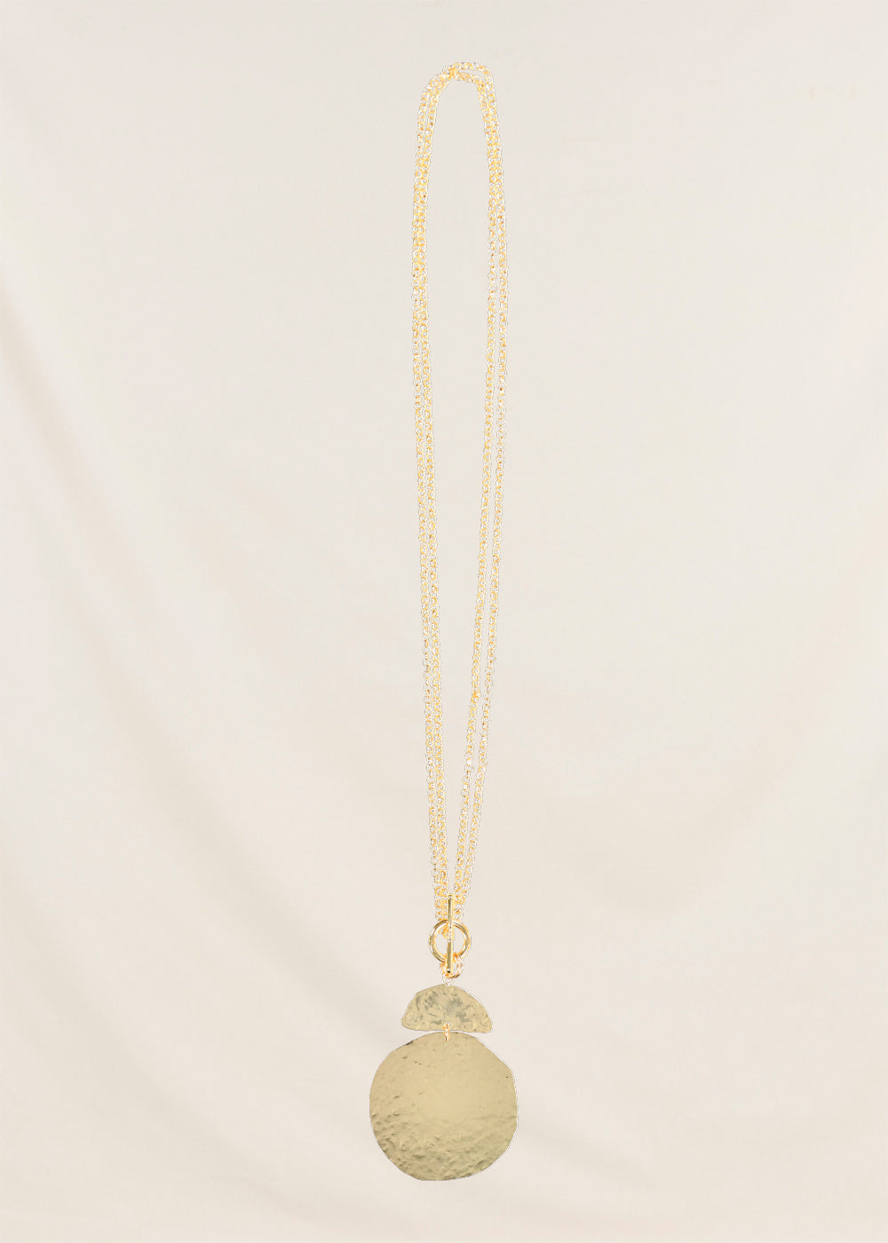Collier sautoir pièce martelée doré